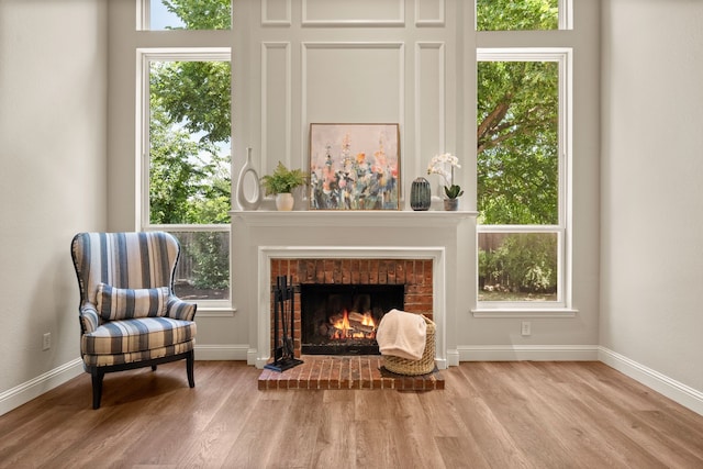 3312 John Ct N, Hurst, TX 76054 - sitting room featuring wood finished floors and a brick fireplace