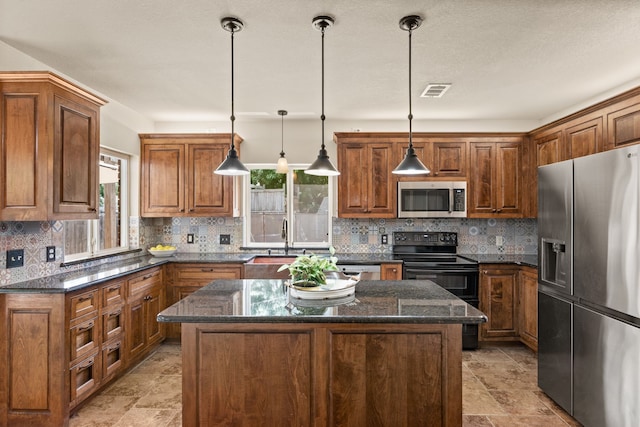 3312 John Ct N, Hurst, TX 76054 - kitchen featuring stainless steel appliances, plenty of natural light, brown cabinetry, and a kitchen island