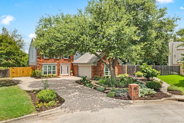 3312 John Ct N, Hurst, TX 76054 - view of property hidden behind natural elements with a garage, concrete driveway, and brick siding