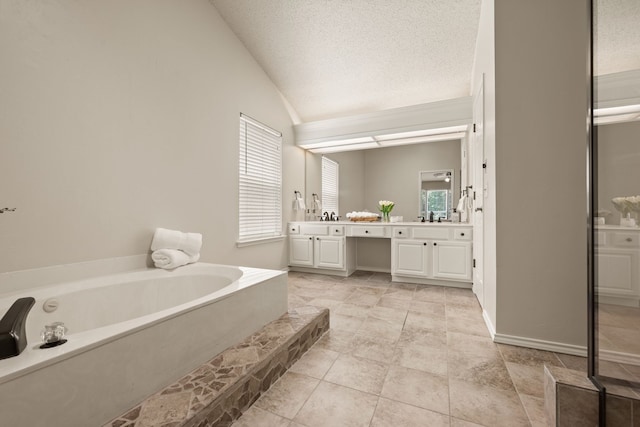 3312 John Ct N, Hurst, TX 76054 - full bath featuring vaulted ceiling, double vanity, a garden tub, and a textured ceiling