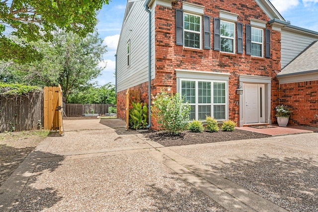 3312 John Ct N, Hurst, TX 76054 - view of front of home with brick siding, a patio, and concrete driveway