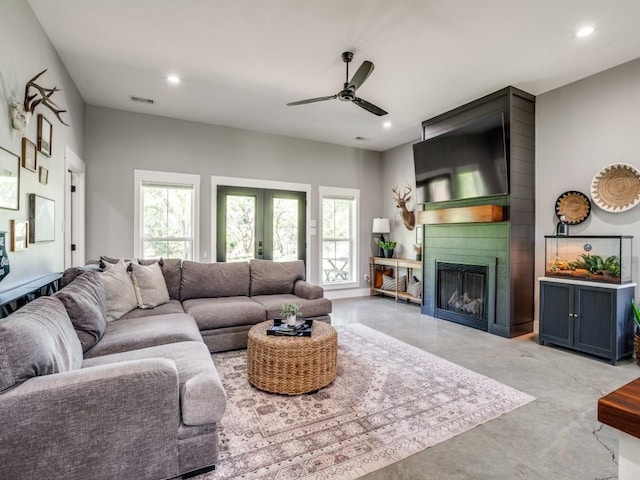 245 Vickie Ln, Gunter, TX 75058 - living area featuring ceiling fan, healthy amount of natural light, finished concrete flooring, a large fireplace, and recessed lighting