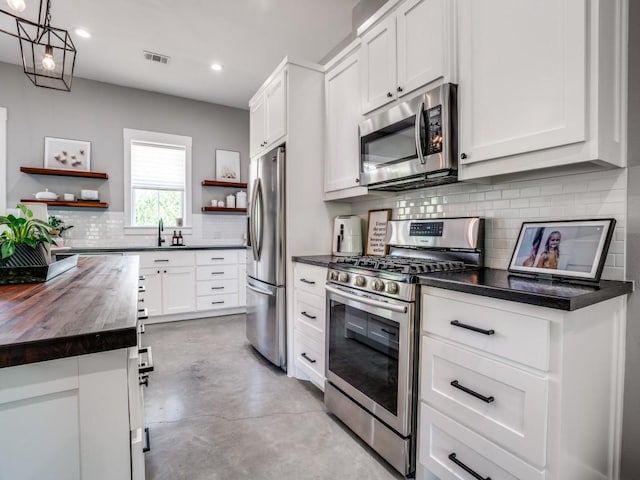 245 Vickie Ln, Gunter, TX 75058 - kitchen featuring stainless steel appliances, wooden counters, open shelves, backsplash, and concrete flooring