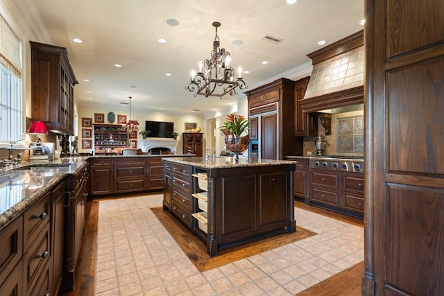 3048 Concord Pl, Tyler, TX 75701 - kitchen with paneled built in refrigerator, stainless steel gas stovetop, ornamental molding, dark brown cabinets, and recessed lighting