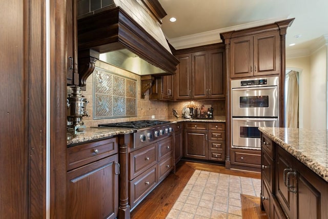 3048 Concord Pl, Tyler, TX 75701 - kitchen with stainless steel appliances, ornamental molding, tasteful backsplash, custom exhaust hood, and dark wood-style flooring