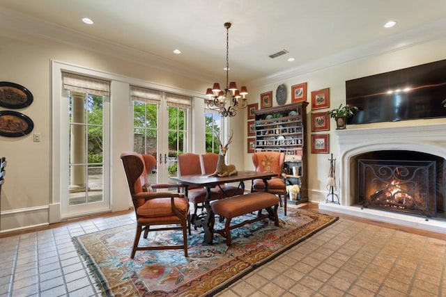 3048 Concord Pl, Tyler, TX 75701 - tiled dining space featuring a chandelier, crown molding, recessed lighting, and a lit fireplace
