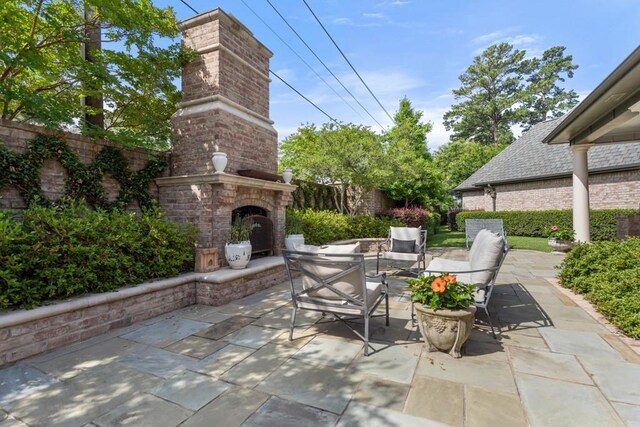 3048 Concord Pl, Tyler, TX 75701 - view of patio with an outdoor brick fireplace