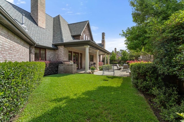 3048 Concord Pl, Tyler, TX 75701 - rear view of property featuring a high end roof, a patio area, a lawn, and brick siding