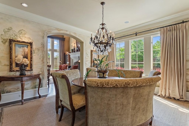 3048 Concord Pl, Tyler, TX 75701 - dining space with a chandelier, crown molding, arched walkways, recessed lighting, and a fireplace