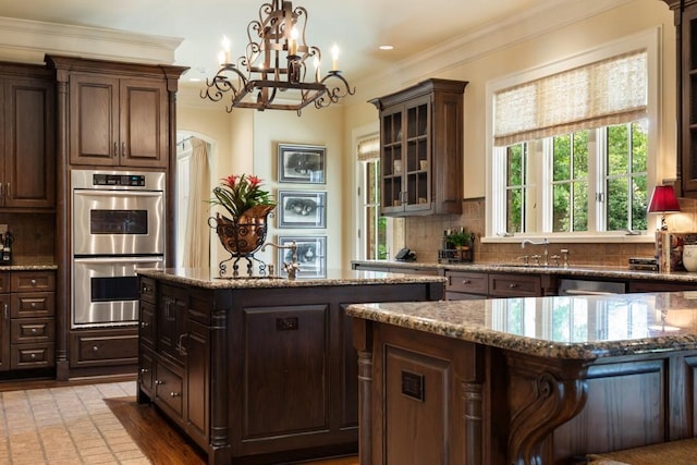 3048 Concord Pl, Tyler, TX 75701 - kitchen featuring stainless steel double oven, ornamental molding, dark brown cabinets, backsplash, and recessed lighting