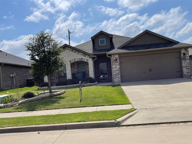 2314 Peggeys Cv, Sherman, TX 75092 - view of front facade featuring a front lawn, an attached garage, concrete driveway, brick siding, and roof with shingles