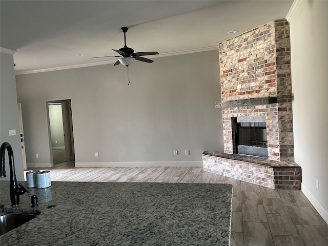 2314 Peggeys Cv, Sherman, TX 75092 - unfurnished living room featuring a ceiling fan, crown molding, wood finished floors, a fireplace, and recessed lighting
