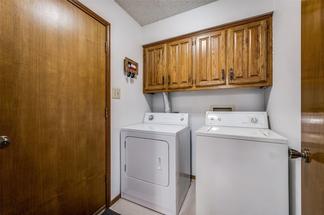 2917 Fladger St, Denton, TX 76207 - laundry room with washing machine and dryer, cabinet space, and a textured ceiling