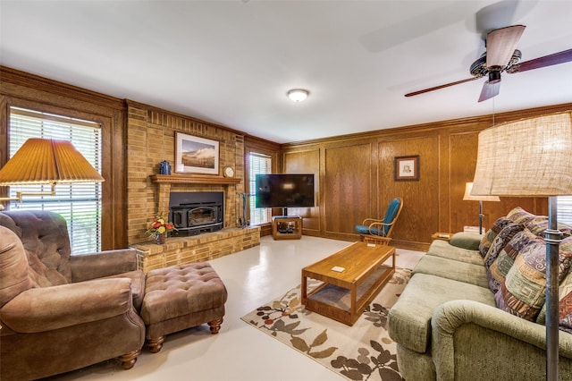 2917 Fladger St, Denton, TX 76207 - living area with finished concrete flooring, a ceiling fan, a wood stove, and wooden walls
