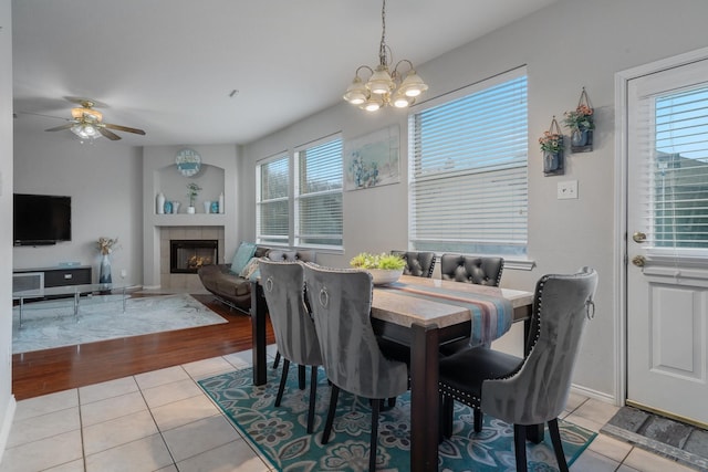 2625 Hudson Xing, Mckinney, TX 75072 - dining space with light tile patterned floors, healthy amount of natural light, a chandelier, and a ceiling fan