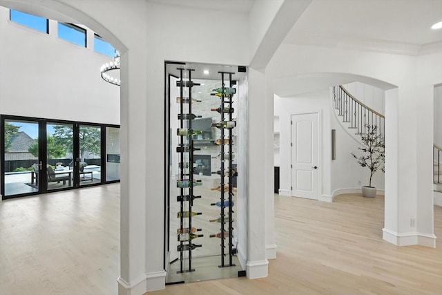 320 W Highland St, Southlake, TX 76092 - wine area with wood finished floors, a towering ceiling, recessed lighting, and arched walkways