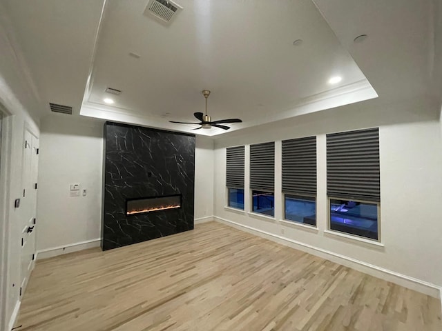 320 W Highland St, Southlake, TX 76092 - unfurnished living room featuring a tray ceiling, wood finished floors, recessed lighting, a fireplace, and a ceiling fan