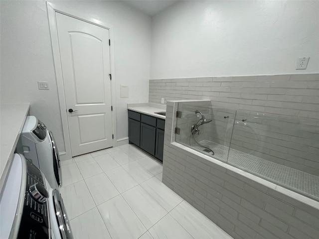 320 W Highland St, Southlake, TX 76092 - full bathroom with tile patterned floors, a garden tub, vanity, independent washer and dryer, and a tile shower