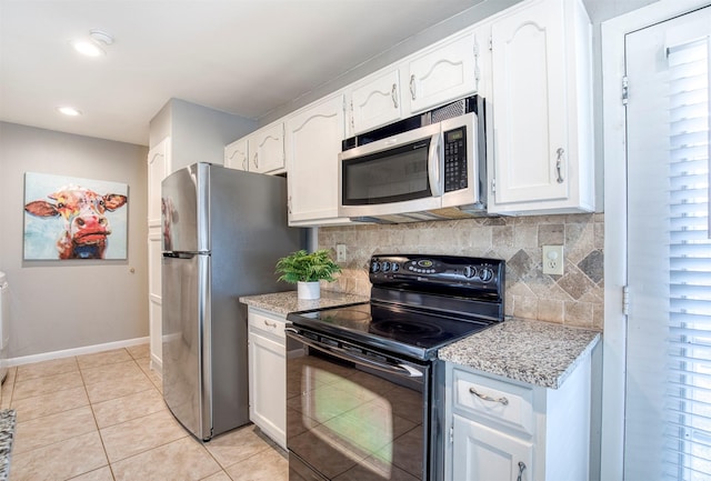 6005 Frontier Ln, Plano, TX 75023 - kitchen featuring appliances with stainless steel finishes, tasteful backsplash, white cabinets, light tile patterned floors, and light stone counters