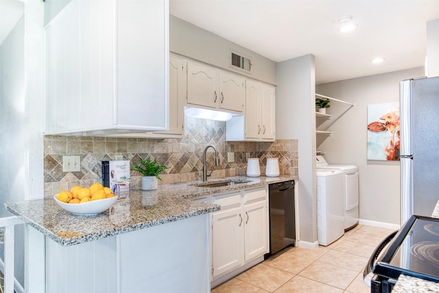 6005 Frontier Ln, Plano, TX 75023 - kitchen featuring dishwasher, freestanding refrigerator, washing machine and dryer, electric stove, and white cabinets