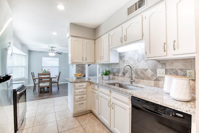 6005 Frontier Ln, Plano, TX 75023 - kitchen with black appliances, a ceiling fan, light tile patterned floors, backsplash, and light stone counters