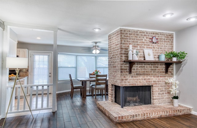 6005 Frontier Ln, Plano, TX 75023 - living area with dark wood finished floors, ceiling fan, a brick fireplace, and recessed lighting