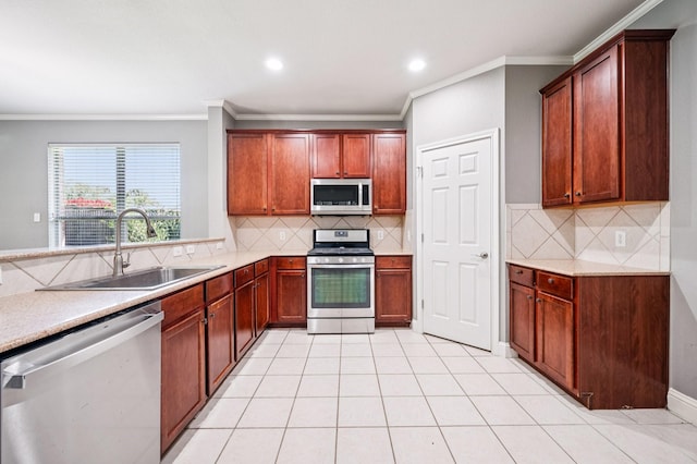 3900 Ironstone Ln, Mckinney, TX 75070 - kitchen featuring stainless steel appliances, crown molding, backsplash, light tile patterned floors, and recessed lighting