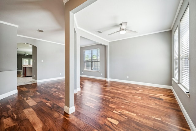3900 Ironstone Ln, Mckinney, TX 75070 - empty room featuring a ceiling fan, arched walkways, wood finished floors, and crown molding