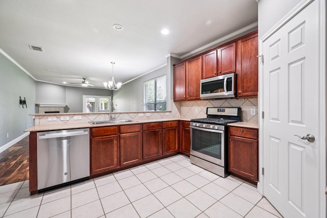 3900 Ironstone Ln, Mckinney, TX 75070 - kitchen featuring stainless steel appliances, ornamental molding, a peninsula, backsplash, and recessed lighting