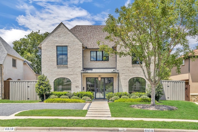 6819 Park Ln, Dallas, TX 75225 - view of front facade with brick siding, a standing seam roof, and roof with shingles