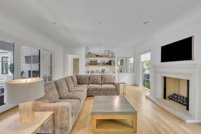 6819 Park Ln, Dallas, TX 75225 - living area with light wood-style floors, a fireplace with raised hearth, ornamental molding, and recessed lighting