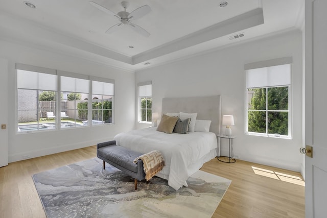 6819 Park Ln, Dallas, TX 75225 - bedroom featuring a raised ceiling, wood finished floors, ornamental molding, and ceiling fan