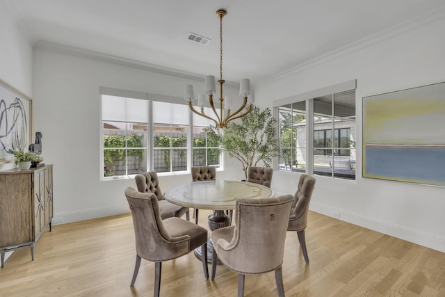 6819 Park Ln, Dallas, TX 75225 - dining room with a chandelier, light wood-style flooring, and ornamental molding