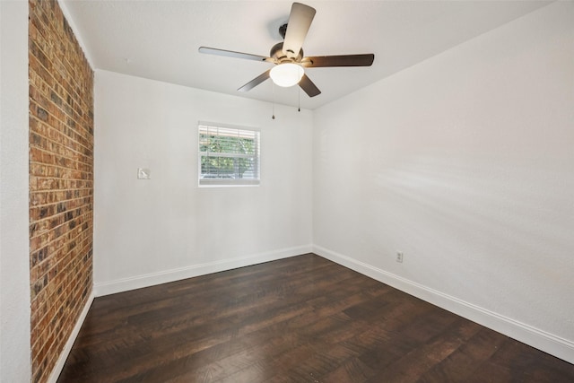 321 Malero Dr, Grand Prairie, TX 75051 - empty room with dark wood-style floors, a ceiling fan, and brick wall
