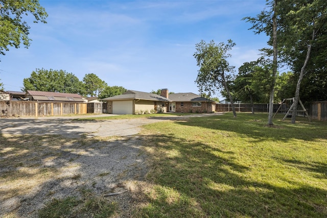 321 Malero Dr, Grand Prairie, TX 75051 - view of yard featuring driveway and a garage