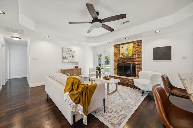 321 Malero Dr, Grand Prairie, TX 75051 - living room with a tray ceiling, recessed lighting, a fireplace, dark wood-style floors, and ceiling fan