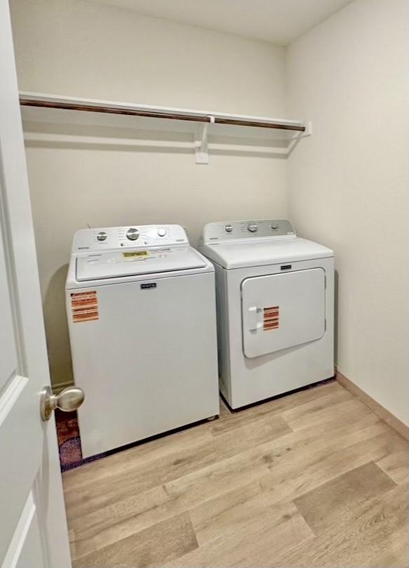 2808 Jasmine Dr, Sherman, TX 75092 - laundry area featuring washing machine and clothes dryer and light wood-style floors