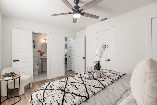 1105 Trellis Dr, Garland, TX 75040 - bedroom featuring light wood-style floors, connected bathroom, and a ceiling fan