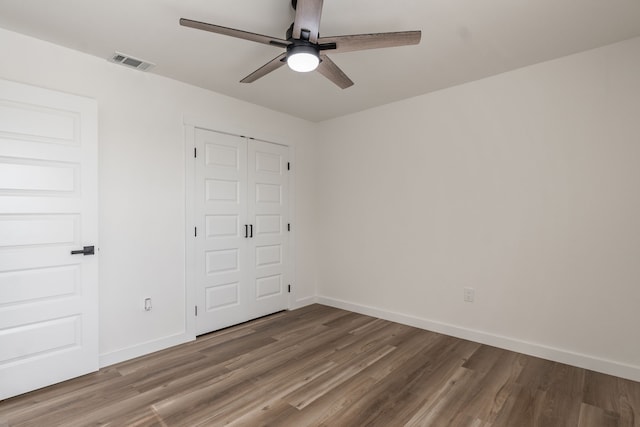 1105 Trellis Dr, Garland, TX 75040 - unfurnished bedroom with wood finished floors, a closet, and ceiling fan