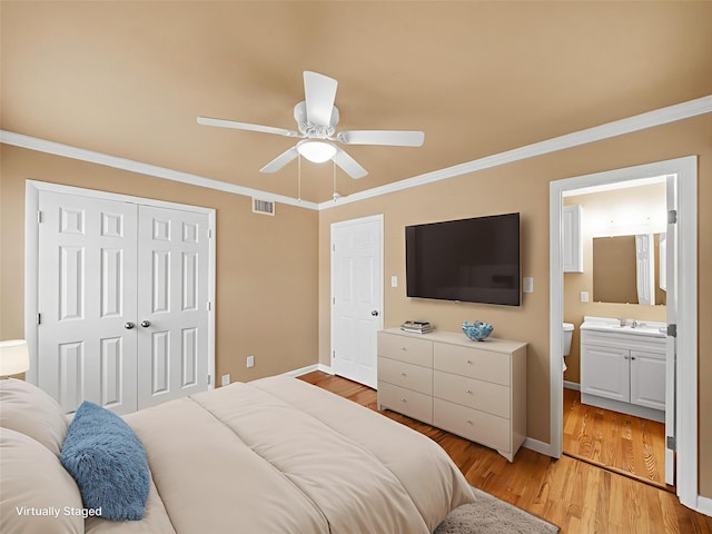 903 20th St, Plano, TX 75074 - bedroom with ornamental molding, a closet, light wood-type flooring, ceiling fan, and ensuite bath