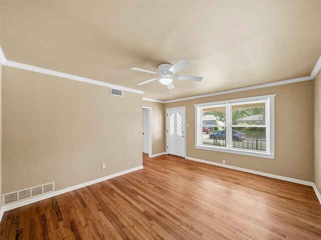 903 20th St, Plano, TX 75074 - spare room featuring light wood-style flooring, a ceiling fan, and ornamental molding