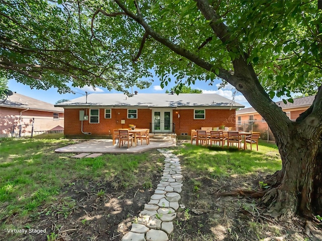 903 20th St, Plano, TX 75074 - back of property with french doors, brick siding, and a patio