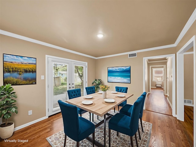903 20th St, Plano, TX 75074 - dining room featuring wood finished floors, french doors, and crown molding