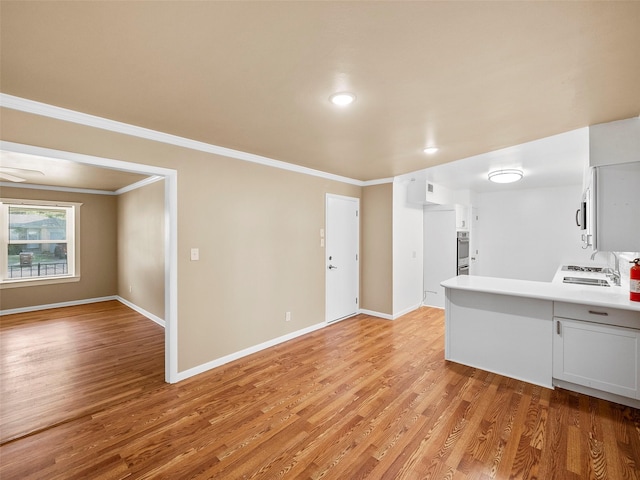 903 20th St, Plano, TX 75074 - kitchen featuring light wood-type flooring, crown molding, light countertops, and recessed lighting