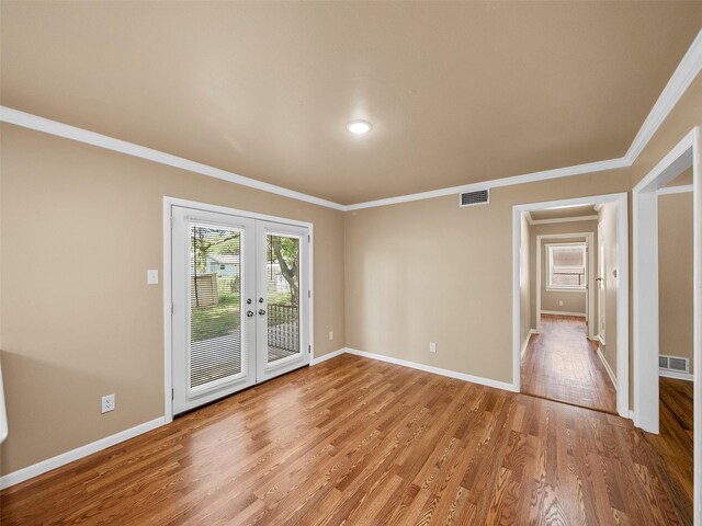 903 20th St, Plano, TX 75074 - empty room featuring light wood-type flooring, french doors, and ornamental molding