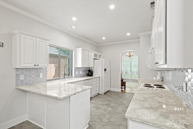 6749 Misty Hollow Dr, Plano, TX 75024 - kitchen with white appliances, crown molding, a peninsula, recessed lighting, and white cabinetry
