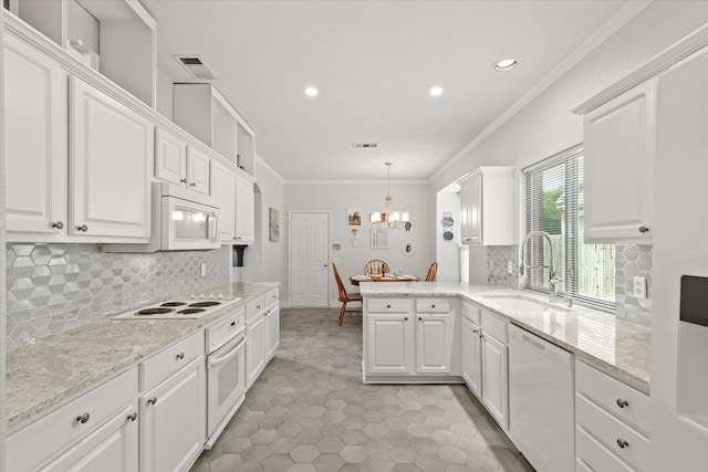 6749 Misty Hollow Dr, Plano, TX 75024 - kitchen with white appliances, white cabinetry, crown molding, decorative backsplash, and recessed lighting