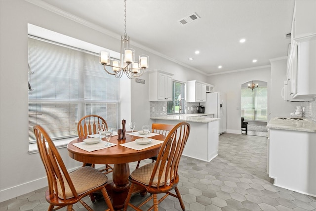 6749 Misty Hollow Dr, Plano, TX 75024 - dining space featuring a chandelier, crown molding, and recessed lighting