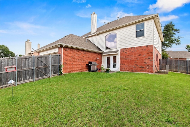 6749 Misty Hollow Dr, Plano, TX 75024 - rear view of house with brick siding, french doors, a gate, a fenced backyard, and a chimney