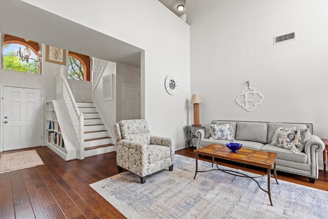 6749 Misty Hollow Dr, Plano, TX 75024 - living area with a towering ceiling, stairs, and hardwood / wood-style floors